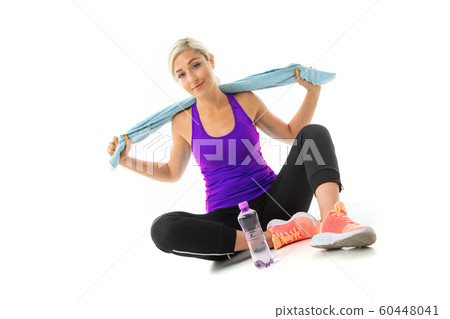blond girl in a sports uniform with a towel on the floor on a white background blond girl in a sports uniform with a towel on the floor on a white background 60448041