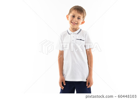 smiling boy with brown hair and bangs on a white background with copy space smiling boy with brown hair and bangs on a white background with copy space 60448103