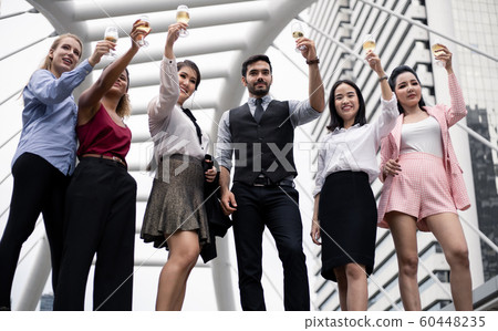 Group of business people celebrate by drinking Group of business people celebrate by drinking 60448235