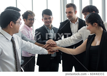 Join hands of team of Asian people and foreigners. Join hands of team of Asian people and foreigners. 60448331