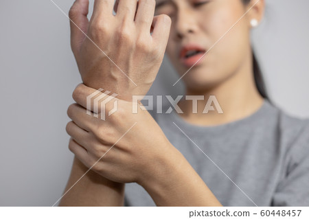 Woman suffering from pain in wrist. Woman suffering from pain in wrist. 60448457