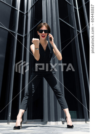 Caucasian office woman call the phone and have a great deal near the office building Caucasian office woman call the phone and have a great deal near the office building 60448887