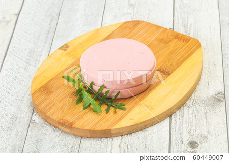 Sliced sausage over the wooden board Sliced sausage over the wooden board 60449007