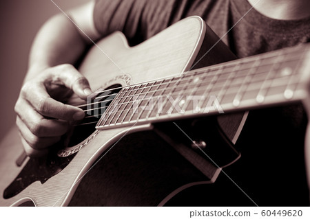 Musicians are playing acoustic guitar. 60449620