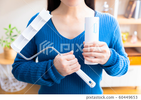 Woman replacing adhesive cleaner 60449653