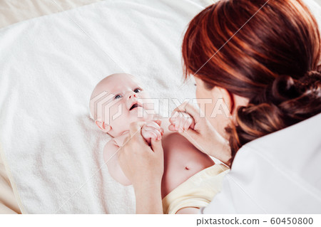 the little boy baby mother doing massage hands and legs the little boy baby mother doing massage hands and legs 60450800
