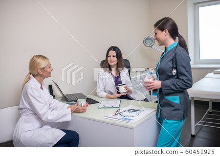 Doctors in neurologycal clinic talking after the shift 60451925