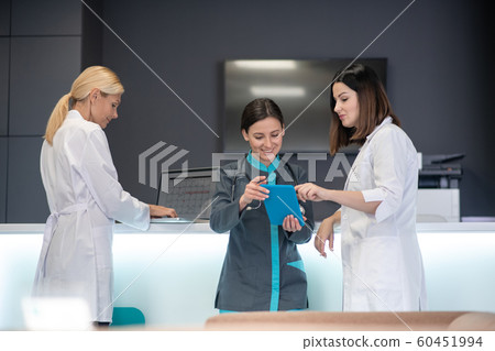 Beautiful female doctors watching something online with interest 60451994