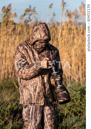 Nature photographer in action. Nature photographer in action. 60452139