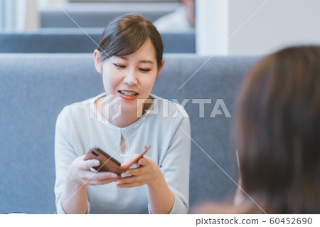 30s female messing around with smartphone 60452690