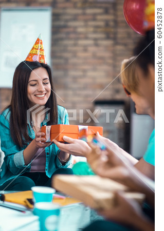 Beautiful birthday girl feeling excited while getting many presents 60452878