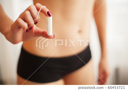 Female Hygiene. Close Up Of Woman Slim Body In Panties Holding Tampon 60453721