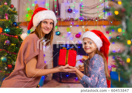 Mom and daughter hold a gift and looked into the 60453847