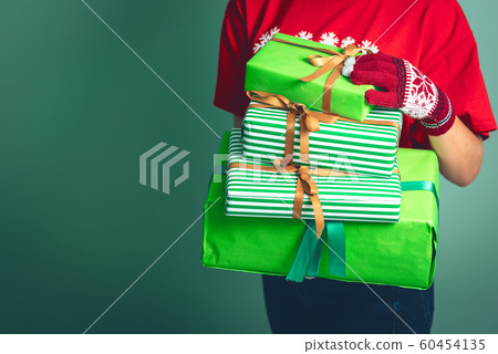 Girl holding a boxes with a gift for Christmas 2019. Girl holding a boxes with a gift for Christmas 2019. 60454135