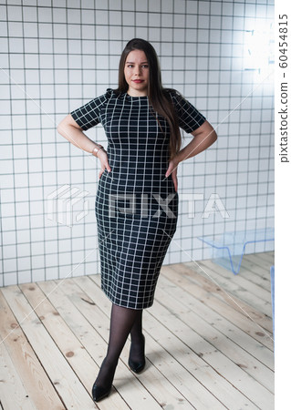 Happy beautiful and confident plus size girl posing in studio Happy beautiful and confident plus size girl posing in studio 60454815