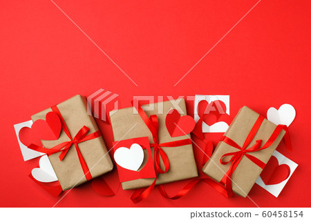 Gift craft boxes with origami paper hearts on red 60458154