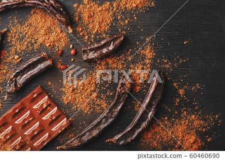 Carob chocolate and carob fruit powder on dark Carob chocolate and carob fruit powder on dark 60460690