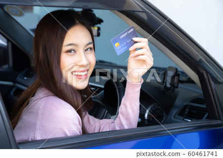 Happy beautiful Asian woman sitting inside new car Happy beautiful Asian woman sitting inside new car 60461741