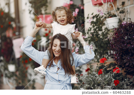 Mother with daughter playing in a summer city 60463288