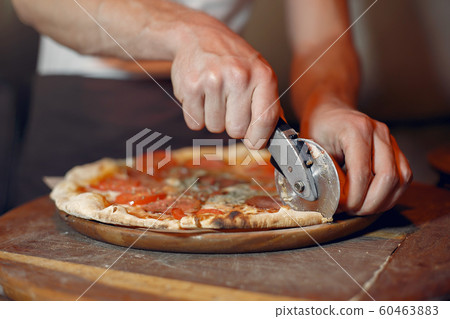Chef in a white uniform prepare a pizzaa Chef in a white uniform prepare a pizzaa 60463883