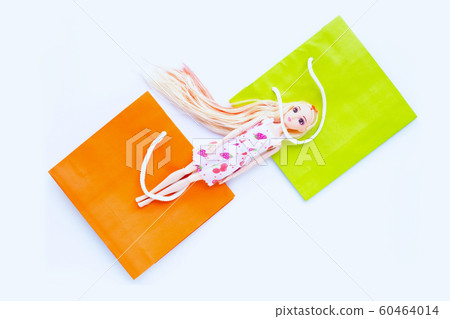 Woman doll with paper shopping bags on white Woman doll with paper shopping bags on white 60464014