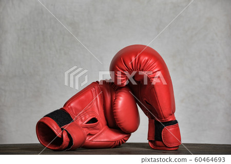 Pair of red boxing gloves on a white background. 60464693