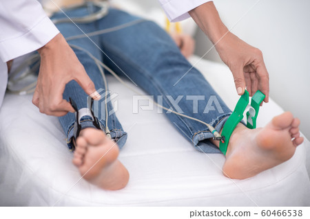 Doctor in white robe fixing equipment for electrocardiogram Doctor in white robe fixing equipment for electrocardiogram 60466538