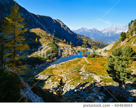 Calm autumn Alps mountain lake with clear Calm autumn Alps mountain lake with clear 60469665