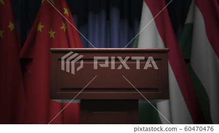 Row of flags of Hungary and China and and speaker tribune, conceptual 3D rendering Row of flags of Hungary and China and and speaker tribune, conceptual 3D rendering 60470476