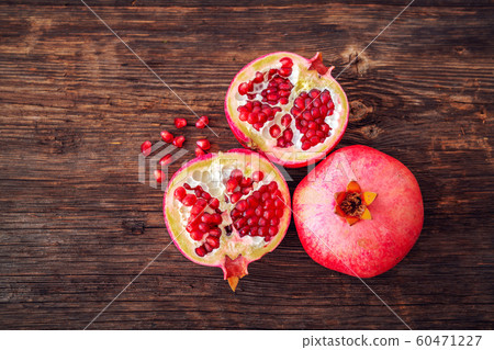 Ripe and fresh pomegranate peeled and ready for eat on wooden beackground 60471227