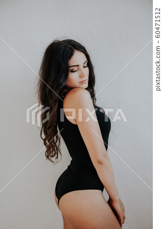nice girl in black body posing in the Studio nice girl in black body posing in the Studio 60471512