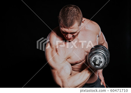 Sport the athlete bodybuilder build muscles dumbbells 60471710