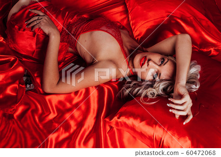 sexy blonde in red underwear lies on a bed sexy blonde in red underwear lies on a bed 60472068