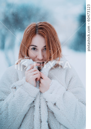 Portrait female model outside in first snow Portrait female model outside in first snow 60473123