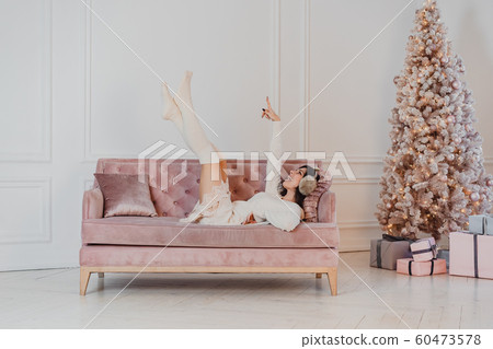 Beautiful woman is lying on the sofa. Beautiful woman is lying on the sofa. 60473578