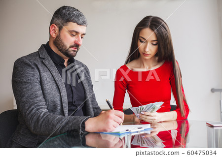 Business Woman Gives Money to Men. Woman Dressed in Red Dress Gives Bribe. Business Man In Gray Jacket Gets Bribe. High Resolution 60475034