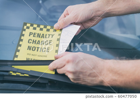 Parking ticket under windshield wiper 60477050