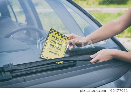 Parking ticket under windshield wiper 60477051