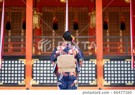 Geishas girl wearing Japanese kimono among red Geishas girl wearing Japanese kimono among red 60477160
