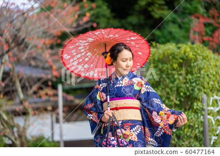 Geishas girl wearing Japanese kimono among red Geishas girl wearing Japanese kimono among red 60477164