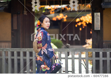 Geishas girl wearing Japanese kimono among red 60477166