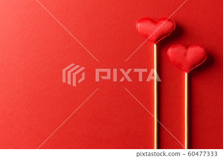Red textile hearts on wooden sticks closeup Red textile hearts on wooden sticks closeup 60477333