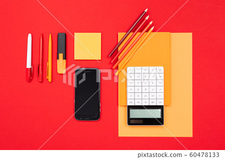 School and office supplies lie neatly on a red background 60478133