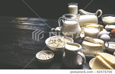 Dairy products on black wooden background, photo filtered in vintage style 60478706