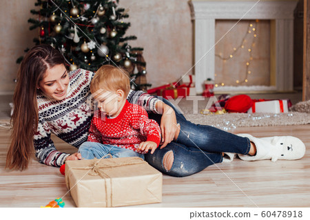 mother with a small child Christmas Decor Gifts Christmas tree 60478918