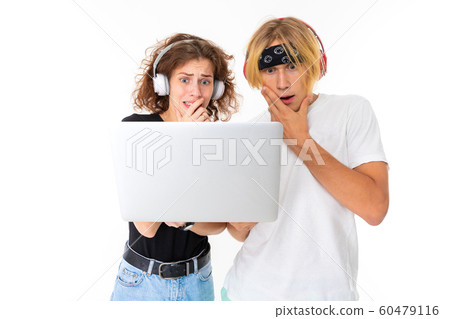Stylish caucasian blonde man and young woman watch an interesting film or serial and listen to music Stylish caucasian blonde man and young woman watch an interesting film or serial and listen to music 60479116