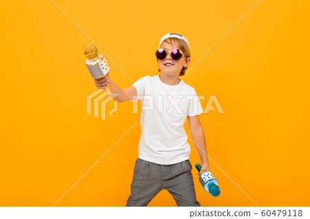 stylish boy with two microphones sings on a yellow bright background stylish boy with two microphones sings on a yellow bright background 60479118