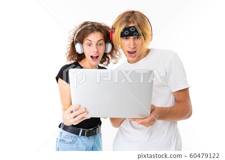 Stylish caucasian blonde man and young woman watch an interesting film or serial and listen to music Stylish caucasian blonde man and young woman watch an interesting film or serial and listen to music 60479122