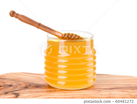 Glass jar full of honey and wooden dipper on wooden plank isolated on white Glass jar full of honey and wooden dipper on wooden plank isolated on white 60481272