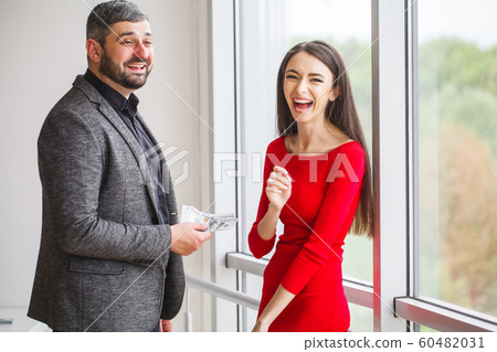Business. Business Woman Gives Money to Men. Woman Dressed in Red Dress Gives Bribe. Business Man In Gray Jacket Gets Bribe. High Resolution Business. Business Woman Gives Money to Men. Woman Dressed in Red Dress Gives Bribe. Business Man In Gray Jacket Gets Bribe. High Resolution 60482031